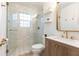 Modern bathroom featuring glass-enclosed shower, wood vanity, gold fixtures, and stylish tile floor at 35 Sheridan Ne Dr # 7, Atlanta, GA 30305