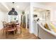 Dining area and view to kitchen with hardwood floors and statement lighting at 35 Sheridan Ne Dr # 7, Atlanta, GA 30305