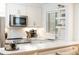 Updated kitchen with white cabinets, stainless steel appliances, subway tile, and open shelving at 35 Sheridan Ne Dr # 7, Atlanta, GA 30305