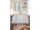 Kitchen featuring white subway tile backsplash, hardwood floors, stainless appliances, and open shelving at 35 Sheridan Ne Dr # 7, Atlanta, GA 30305