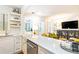 Bright, eat-in kitchen with white cabinets, quartz countertops, stainless steel appliances, and view into living room at 35 Sheridan Ne Dr # 7, Atlanta, GA 30305