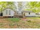 Backyard with a small deck and mature trees providing shade at 4507 Laurie Ln, Powder Springs, GA 30127