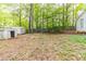 View of the private backyard with mature trees and two storage sheds at 4507 Laurie Ln, Powder Springs, GA 30127