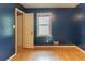 Bedroom with hardwood floors, window, and open closet at 4507 Laurie Ln, Powder Springs, GA 30127