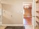 Hallway with tiled floors, light fixtures, with view of other room with chandelier and hardwood floors at 4507 Laurie Ln, Powder Springs, GA 30127