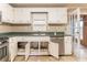 Kitchen with white cabinets, stainless steel appliances, and tiled floors with door to an adjacent room at 4507 Laurie Ln, Powder Springs, GA 30127