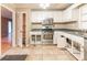 Bright kitchen with stainless steel appliances, white cabinetry, tiled floors, and good natural light at 4507 Laurie Ln, Powder Springs, GA 30127
