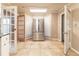 Open kitchen area featuring tiled floors, stainless steel refrigerator and double doors and good light at 4507 Laurie Ln, Powder Springs, GA 30127