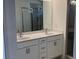 Bathroom featuring double sinks, white cabinets and a stand-up shower at 1616 Avery Way, Tucker, GA 30084
