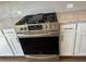 Stainless steel gas range with white cabinets and granite counter tops at 1616 Avery Way, Tucker, GA 30084