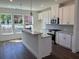 Bright and modern kitchen featuring an island, granite countertops, and stainless steel appliances at 1616 Avery Way, Tucker, GA 30084