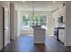 Bright, open kitchen featuring a center island, stainless appliances, and hardwood floors at 1616 Avery Way, Tucker, GA 30084