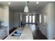 Open-concept kitchen with granite counters, island, stainless appliances, and dark hardwood floors at 1616 Avery Way, Tucker, GA 30084