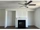 Cozy living room featuring a fireplace with white mantle and recessed media shelves at 1616 Avery Way, Tucker, GA 30084