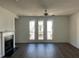 Bright living room with a fireplace, French doors to a balcony, and hardwood floors at 1616 Avery Way, Tucker, GA 30084