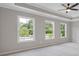 Spacious bedroom with three windows and a ceiling fan at 1954 William Glen St, Dacula, GA 30019