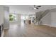 Open living space featuring hardwood floors, staircase, and combined kitchen and dining area at 1954 William Glen St, Dacula, GA 30019
