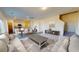 Bright and airy living space with open layout and modern furnishings adjacent to kitchen and dining at 2349 Argento Cir, Dacula, GA 30019