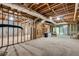 Unfinished basement space with exposed beams and concrete floor, offering potential for customization and expansion at 2680 Spalding Dr, Atlanta, GA 30350