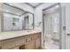 Bathroom featuring a vanity with sink, ample counter space, and view of a private toilet room at 2680 Spalding Dr, Atlanta, GA 30350