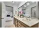 Bathroom showcasing a large mirror, double sinks and modern fixtures, plus a view of an ensuite bedroom at 2680 Spalding Dr, Atlanta, GA 30350