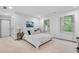 A well-lit bedroom features plantation shutters, a lush green outdoor view and neutral decor at 2680 Spalding Dr, Atlanta, GA 30350