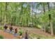 The front yard features mature trees, a landscaped flower bed, and a curving driveway at 2680 Spalding Dr, Atlanta, GA 30350