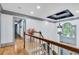 Hallway with hardwood floors, elegant lighting fixture and lots of natural light at 2680 Spalding Dr, Atlanta, GA 30350
