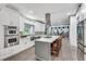 Bright kitchen with stainless appliances, white cabinets, and large island with seating at 2680 Spalding Dr, Atlanta, GA 30350