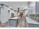 Renovated kitchen features a central island with seating, sleek countertops, and stylish backsplash at 2680 Spalding Dr, Atlanta, GA 30350