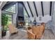 Cozy living room featuring a brick fireplace, beamed ceilings, and comfortable seating at 2680 Spalding Dr, Atlanta, GA 30350
