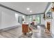 Open-concept living room with hardwood floors, a brick fireplace, and lots of natural light at 2680 Spalding Dr, Atlanta, GA 30350