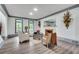 Comfortable living room featuring a fireplace, neutral walls, hardwood floors, and decorative furniture at 2680 Spalding Dr, Atlanta, GA 30350