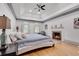 Relaxing main bedroom with fireplace, tray ceiling, and ample natural light at 2680 Spalding Dr, Atlanta, GA 30350