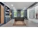 Home office with wainscoting, built-in cabinets and large windows overlooking lush landscape at 2680 Spalding Dr, Atlanta, GA 30350