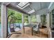 Covered patio with skylights, brick flooring, and stylish furniture, perfect for outdoor dining and relaxation by the pool at 2680 Spalding Dr, Atlanta, GA 30350