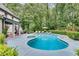 Expansive backyard featuring a refreshing pool, sun loungers, and a tranquil ambiance surrounded by mature trees at 2680 Spalding Dr, Atlanta, GA 30350
