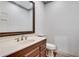 Neat powder room features a decorative mirror and a white toilet at 2680 Spalding Dr, Atlanta, GA 30350