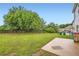 Spacious backyard featuring mature trees and a small patio at 909 Pine Cove Dr, Lilburn, GA 30047