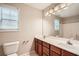 Bathroom boasts double sink vanity with dark wood cabinets and bright vanity lighting at 909 Pine Cove Dr, Lilburn, GA 30047