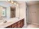 Bathroom with double sink vanity, granite countertops, and a large mirror at 909 Pine Cove Dr, Lilburn, GA 30047