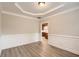 Formal dining room with hardwood floors, wainscoting, and access to the kitchen at 909 Pine Cove Dr, Lilburn, GA 30047