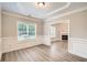 Elegant dining room with beautiful molding, hardwood floors, and views of the living room at 909 Pine Cove Dr, Lilburn, GA 30047