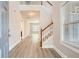 Inviting entryway with hardwood floors, a staircase, and views into the adjacent rooms at 909 Pine Cove Dr, Lilburn, GA 30047