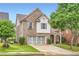 Charming two-story brick home features a two-car garage and well-manicured front yard at 909 Pine Cove Dr, Lilburn, GA 30047