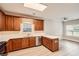 Well-lit kitchen featuring light countertops, wooden cabinetry, and stainless steel appliances at 909 Pine Cove Dr, Lilburn, GA 30047