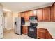 Bright kitchen with stainless steel refrigerator, wood cabinets, and modern appliances at 909 Pine Cove Dr, Lilburn, GA 30047