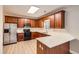 Bright kitchen with stainless steel refrigerator, wood cabinets, and stone countertops at 909 Pine Cove Dr, Lilburn, GA 30047