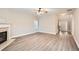Spacious living room with a fireplace, hardwood floors, and an open layout to the entryway at 909 Pine Cove Dr, Lilburn, GA 30047
