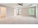 Large main bedroom with plush carpet, tray ceilings, natural light, and walk-in closet access at 909 Pine Cove Dr, Lilburn, GA 30047
